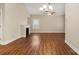 Living area with wood floors, fireplace, and chandelier, offering an inviting atmosphere at 207 Crystal Springs Ln, Shelby, NC 28150