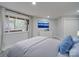 Bright bedroom featuring a large window with wooded views, a comfortable bed, and ample closet space at 2143 Manawa Ln, Tega Cay, SC 29708