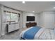 Bright bedroom featuring a large window with wooded views, a comfortable bed, and ample closet space at 2143 Manawa Ln, Tega Cay, SC 29708