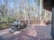 Spacious deck with an outdoor dining area, perfect for entertaining in a wooded setting at 2143 Manawa Ln, Tega Cay, SC 29708