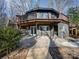 Unique multi-story home with a spacious wraparound deck, offering an ideal setting for outdoor living and entertaining at 2143 Manawa Ln, Tega Cay, SC 29708
