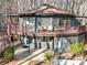Unique home featuring a wrap-around deck, modern design, and wooded surroundings at 2143 Manawa Ln, Tega Cay, SC 29708