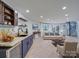 Living room features a bar area with wood cabinetry, a comfortable sitting area, and a spiral staircase at 2143 Manawa Ln, Tega Cay, SC 29708