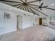 Bright and open living area with vaulted ceilings, hardwood floors, and access to a loft at 2143 Manawa Ln, Tega Cay, SC 29708