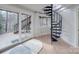 Cozy living room with a spiral staircase, sliding glass door to deck, and light wood flooring at 2143 Manawa Ln, Tega Cay, SC 29708