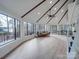 Bright living room featuring vaulted ceilings, large windows with views, and hardwood floors at 2143 Manawa Ln, Tega Cay, SC 29708