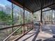 Inviting screened porch offers a relaxing outdoor space with beautiful wooded views at 2143 Manawa Ln, Tega Cay, SC 29708