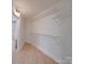 Spacious walk-in closet with wood floor and metal shelving at 2143 Manawa Ln, Tega Cay, SC 29708