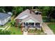 Aerial view of a brick home with a covered porch, manicured lawn, and detached garage at 224 E Steele St, Salisbury, NC 28144