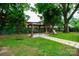 Backyard featuring a gazebo, patio set, and landscaping, ideal for outdoor entertaining at 224 E Steele St, Salisbury, NC 28144