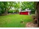 Spacious backyard with outbuilding and mature trees, perfect for outdoor activities at 224 E Steele St, Salisbury, NC 28144