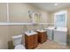 The bathroom features dual vanities and conveniently located washer and dryer at 224 E Steele St, Salisbury, NC 28144
