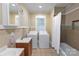 Bathroom featuring a vanity sink and a conveniently located washer and dryer at 224 E Steele St, Salisbury, NC 28144