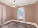 Neutral bedroom with hardwood floors and light fixture, showcasing modern aesthetic at 224 E Steele St, Salisbury, NC 28144