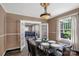 Stylish dining room featuring a glass-top table, modern chairs, and elegant lighting fixture at 224 E Steele St, Salisbury, NC 28144