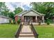Charming brick home with a covered front porch and well-manicured lawn at 224 E Steele St, Salisbury, NC 28144