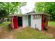 Red and white outbuilding with various entry points and storage at 224 E Steele St, Salisbury, NC 28144