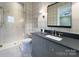 Bathroom showcasing a glass shower, gray vanity with a sleek countertop, and modern fixtures at 2270 New Gray Rock Rd, Fort Mill, SC 29708