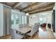 Bright dining room with wood beam ceilings, hardwood floors and large windows providing plenty of natural light at 2270 New Gray Rock Rd, Fort Mill, SC 29708