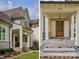 Charming front porch with stone steps, lantern lighting and rocking chairs at 2270 New Gray Rock Rd, Fort Mill, SC 29708