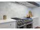 Close-up of high-end stainless steel range and vent hood set against classic white tile backsplash at 2270 New Gray Rock Rd, Fort Mill, SC 29708