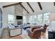 Bright living room with stone fireplace, wood beams, and large windows offering ample natural light at 2270 New Gray Rock Rd, Fort Mill, SC 29708