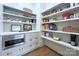Well-organized pantry with custom shelving, cabinetry, and a built-in microwave at 2270 New Gray Rock Rd, Fort Mill, SC 29708