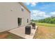 Spacious backyard featuring a sliding door that opens to a patio with a grill at 2340 Lanza Dr, Charlotte, NC 28215