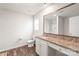 Bathroom with a wood-look floor, granite vanity top, framed mirror, and glass enclosed shower at 2340 Lanza Dr, Charlotte, NC 28215