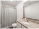 Bright bathroom with granite countertop, framed mirror, and shower with curtain at 2340 Lanza Dr, Charlotte, NC 28215