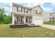Charming two-story home featuring a covered porch, manicured lawn, and attached two-car garage at 2340 Lanza Dr, Charlotte, NC 28215