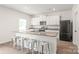 Modern kitchen featuring a large island, granite countertops, stainless steel appliances, and ample storage at 2340 Lanza Dr, Charlotte, NC 28215