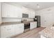Well-equipped kitchen with white cabinets, granite countertops, stainless steel appliances, and hardwood floors at 2340 Lanza Dr, Charlotte, NC 28215