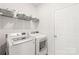 Bright laundry room with shelving and modern washer and dryer at 2340 Lanza Dr, Charlotte, NC 28215