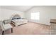Spacious bedroom with vaulted ceilings, plush carpeting, and a decorative bed frame at 2340 Lanza Dr, Charlotte, NC 28215