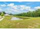 Scenic view of a pond surrounded by lush greenery, enhancing the property's appeal at 2340 Lanza Dr, Charlotte, NC 28215
