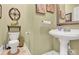 Half bathroom featuring pedestal sink, toilet, neutral paint and tile flooring at 267 Ikerd Se Dr, Concord, NC 28025