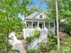 View of the home, revealing an elevated design, and surrounded by mature, verdant foliage at 267 Ikerd Se Dr, Concord, NC 28025