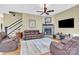 Spacious living area with stone fireplace, plush seating, and ample natural light at 267 Ikerd Se Dr, Concord, NC 28025