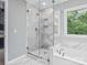 Luxurious bathroom featuring a glass shower, soaking tub, and window with natural light at 2821 Providence Spring Ln, Charlotte, NC 28270