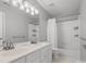 Bathroom featuring a double vanity, shower with white tile, and a soaking tub at 2821 Providence Spring Ln, Charlotte, NC 28270