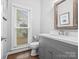 Bathroom featuring a vanity with modern sink, a window, and a framed mirror at 2821 Providence Spring Ln, Charlotte, NC 28270