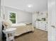 Bright bedroom with a large window, a comfortable bed, and decorative shelves at 2821 Providence Spring Ln, Charlotte, NC 28270