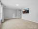 Spacious bonus room with neutral walls and carpet, pre-wired for television at 2821 Providence Spring Ln, Charlotte, NC 28270