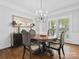 Formal dining room with dark wood table, hardwood floors, and traditional decor at 2821 Providence Spring Ln, Charlotte, NC 28270