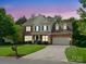 Charming two-story brick home featuring a manicured lawn and attached two-car garage at 2821 Providence Spring Ln, Charlotte, NC 28270