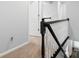 Hallway featuring a dark wood handrail and neutral carpet at 2821 Providence Spring Ln, Charlotte, NC 28270