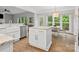 Eat-in kitchen featuring a center island, stainless steel dishwasher, and hardwood floors at 2821 Providence Spring Ln, Charlotte, NC 28270