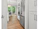 Modern kitchen with stainless steel appliances and white cabinetry seen from pantry at 2821 Providence Spring Ln, Charlotte, NC 28270