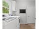 Functional laundry room featuring modern appliances and a window for natural light at 2821 Providence Spring Ln, Charlotte, NC 28270